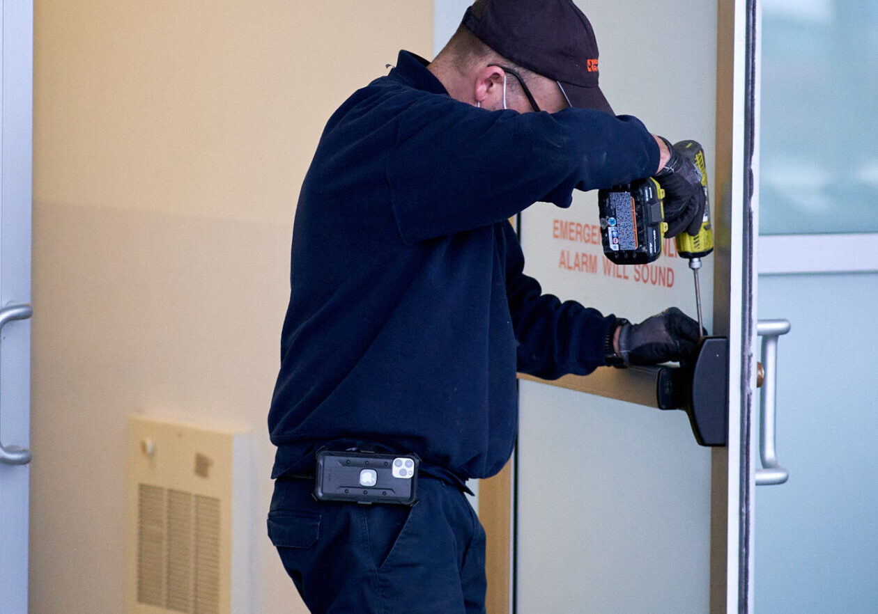 A certified Maintenance Repair Service technician repairs a fire exit door for a local commercial Toronto/Ottawa retail outlet grocery store. 